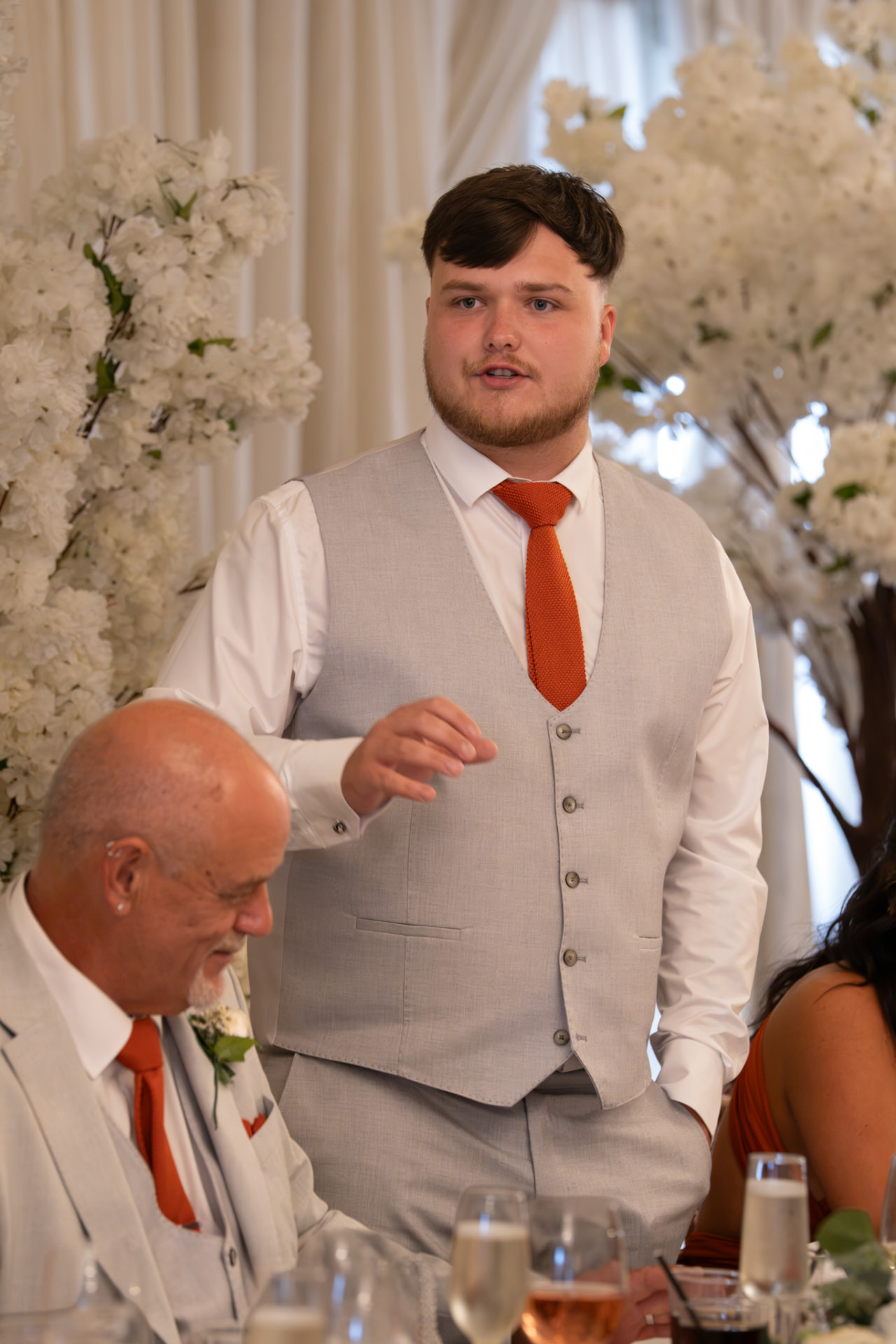 Best man giving his speech among white blossom trees