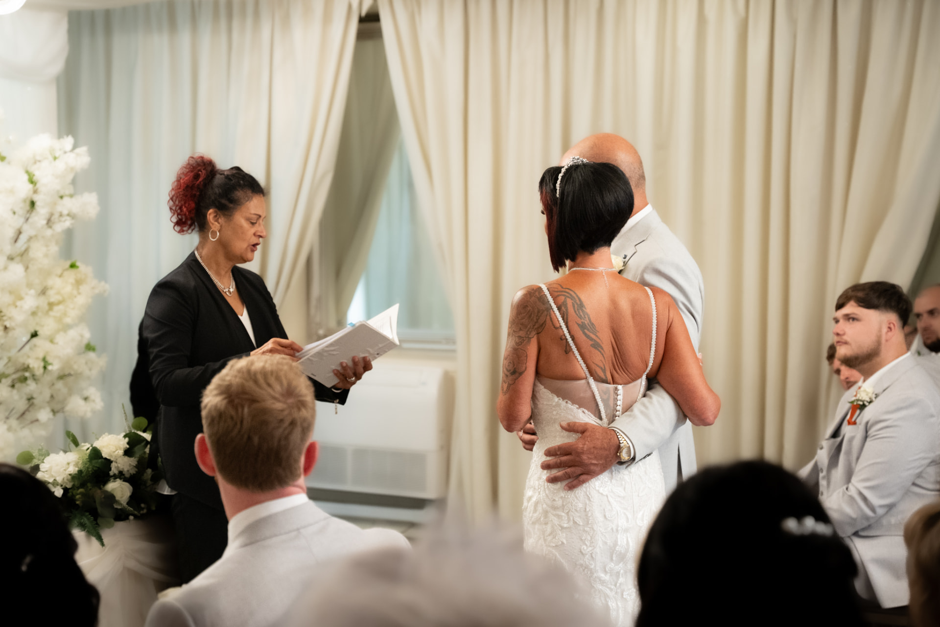 Bride and groom holding each other during their wedding ceremony