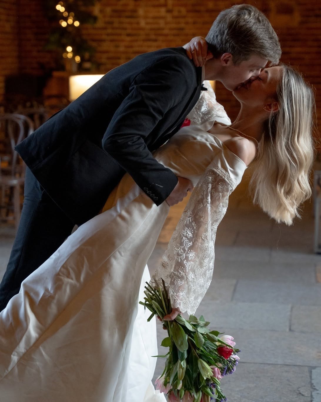 Groom dipping his bride for a kiss during their first dance